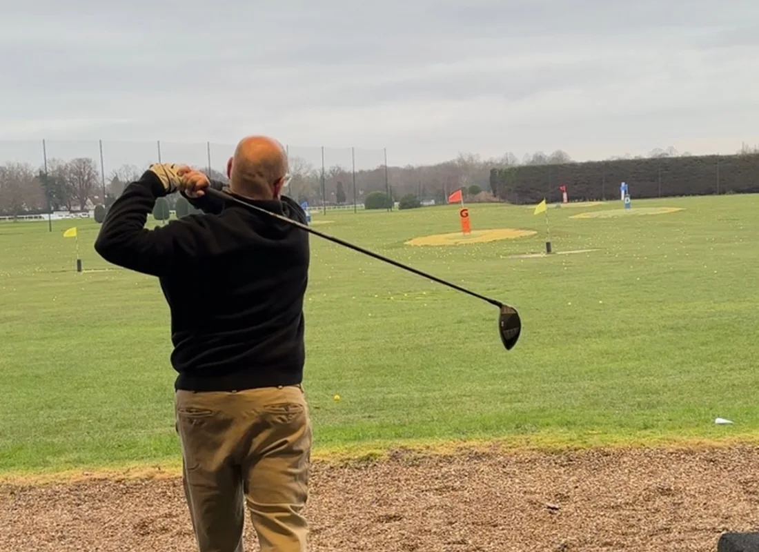 Golf coaching on the driving range at Sandown Park Golf Centre